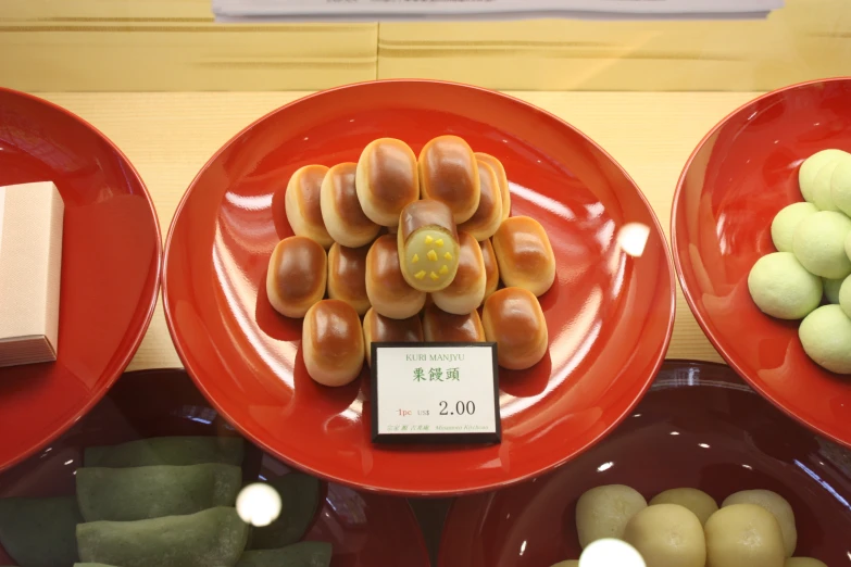 some type of food set on three red plates