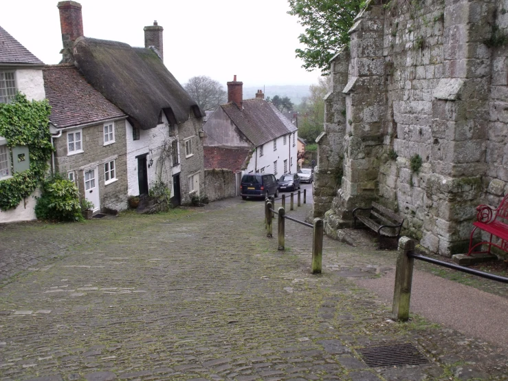 street in an old medieval village with cobblestone street leading to white houses