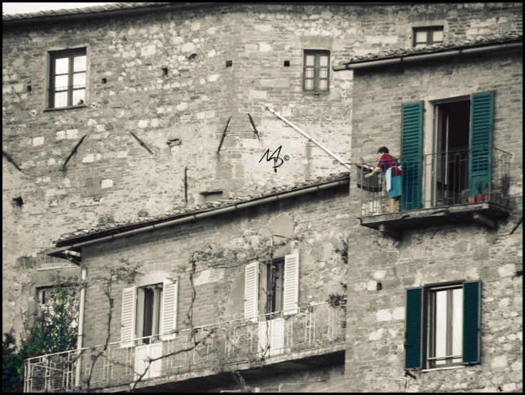 a man is on the window of an old house