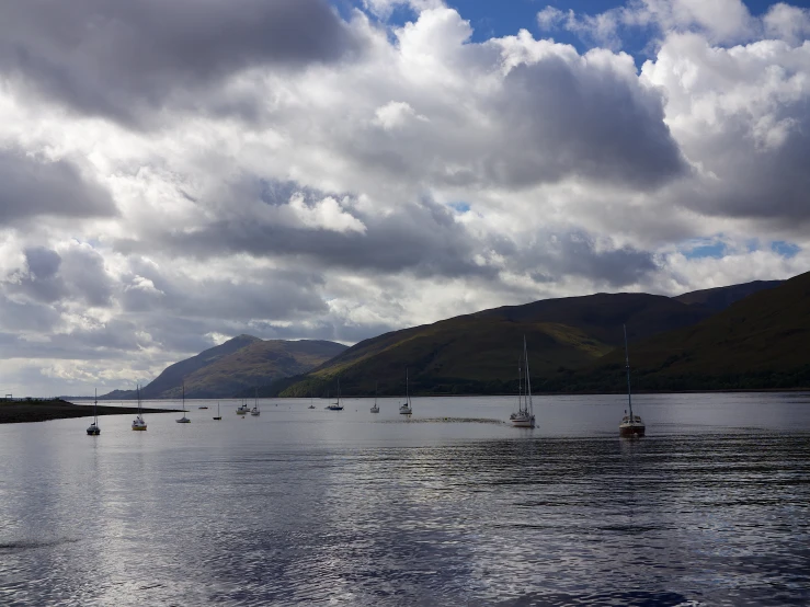 several boats sitting in the middle of a body of water