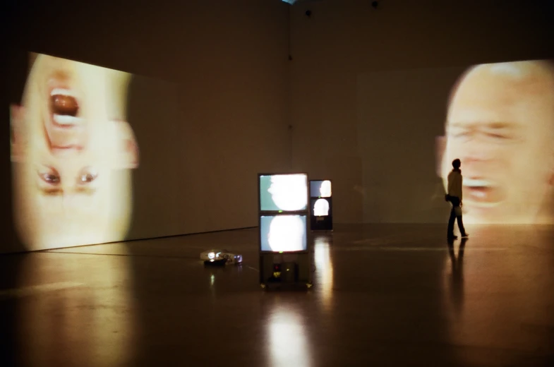 a display in a museum that features an image of a man on stage with his hands up