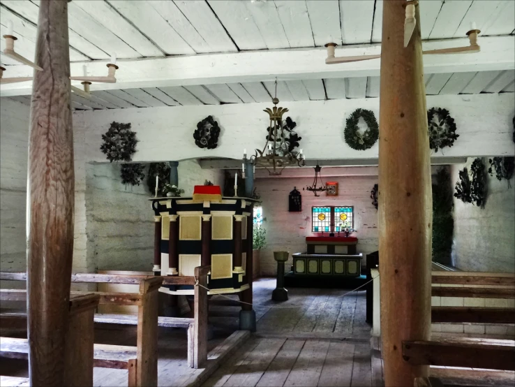 a small church with wood pews lined up