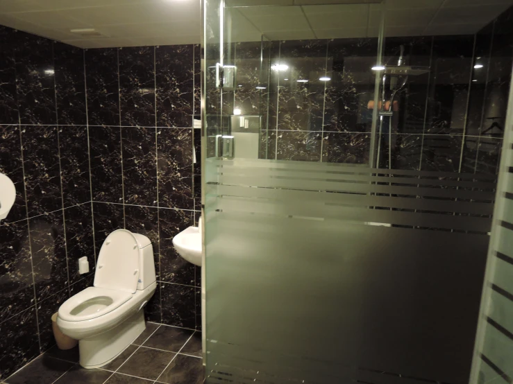 a public bathroom with two toilets and sinks