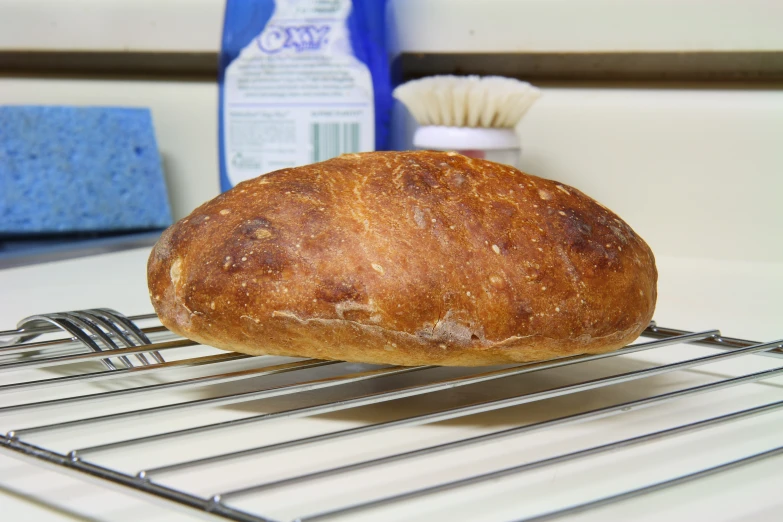 a close up of a loaf of bread on a cooling rack