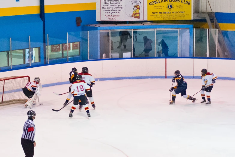 people playing ice hockey inside an indoor arena