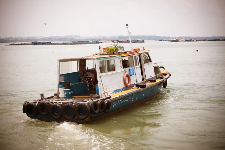 a small ferry boat floating through the ocean