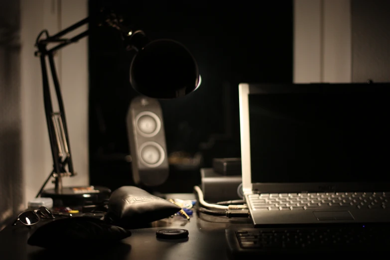 there is a laptop computer and speakers on this desk