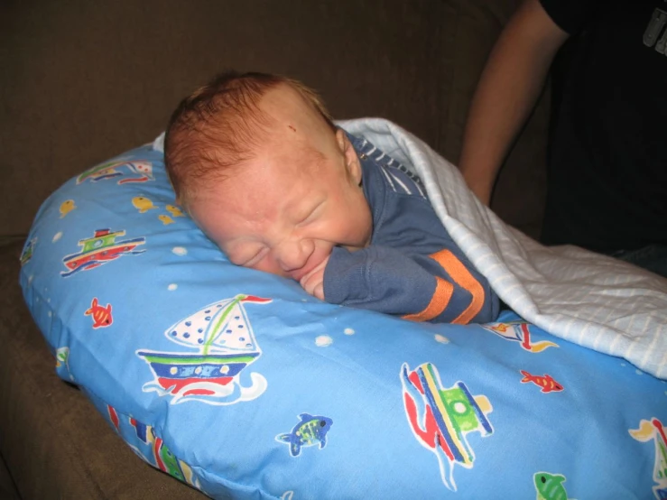 a baby is sleeping on a blue blanket