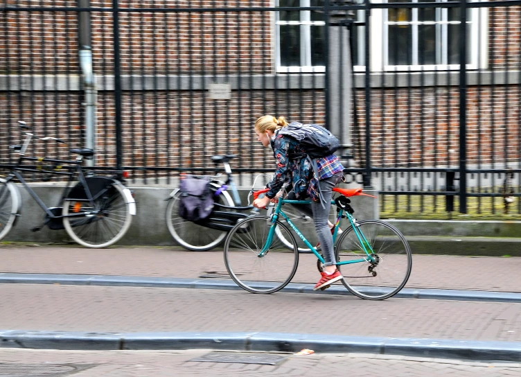 a lady on a bike with several backpacks