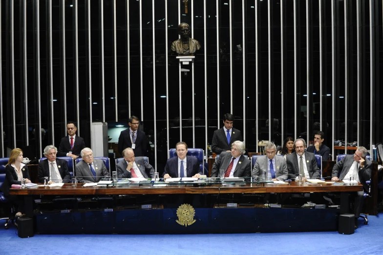 a table is full with people in suits