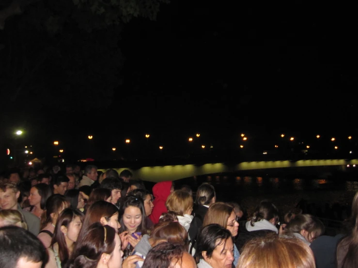 a crowd is gathered around an outdoor concert