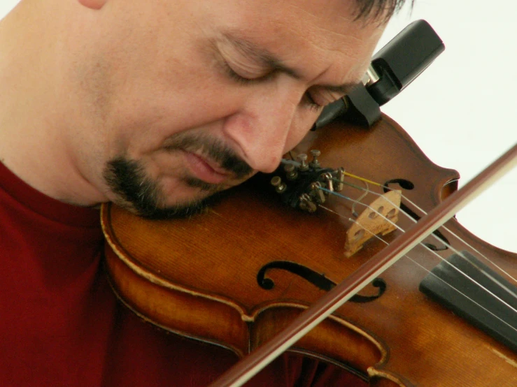 a man playing violin with both hands