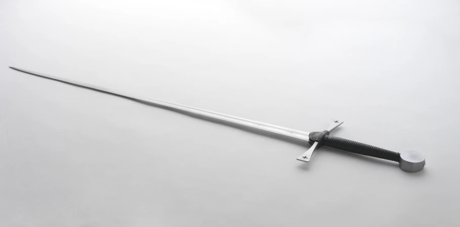 a sword sitting on the ground on a gray surface