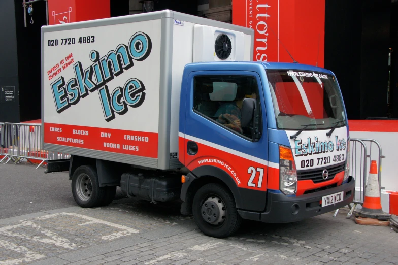 a delivery truck parked in front of a building