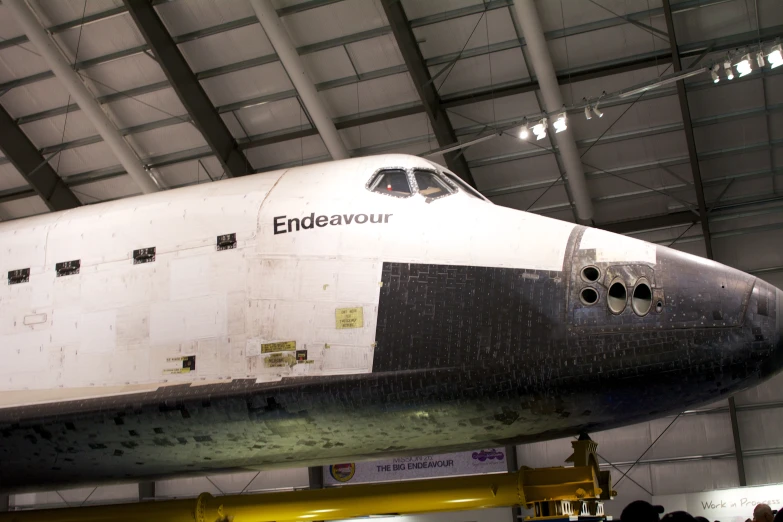 a space shuttle sits on display in a building