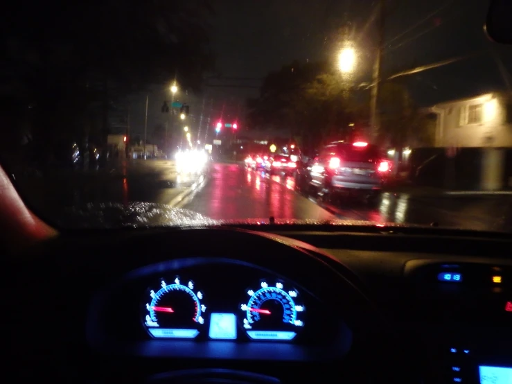 an image of driving on a rainy road at night
