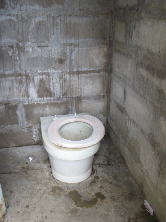 a white toilet in a small room with no walls