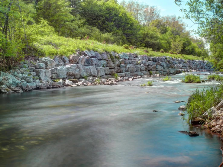 there is a mountain river that is flowing down the stream