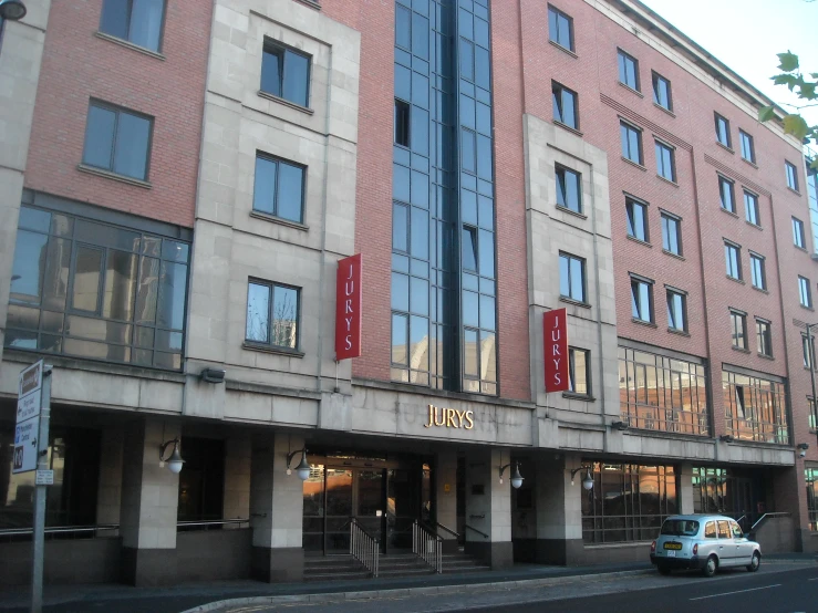 a building with many windows, and an apartment with red lettering