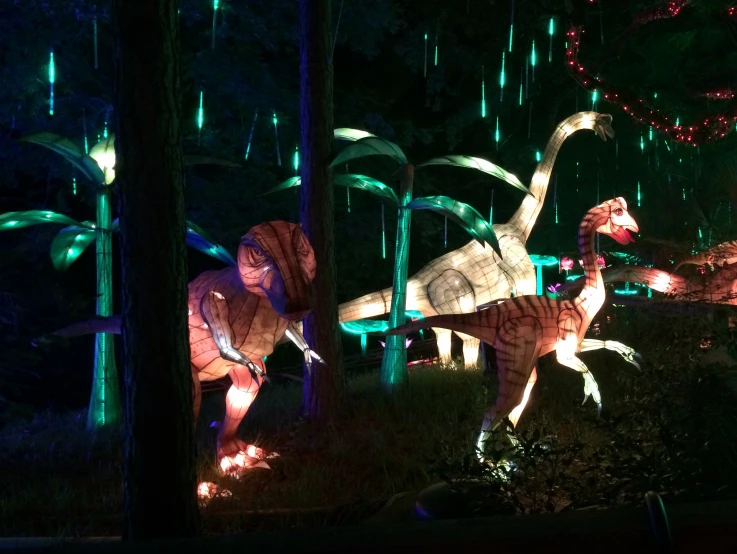 dinosaurs are all illuminated in the dark at night