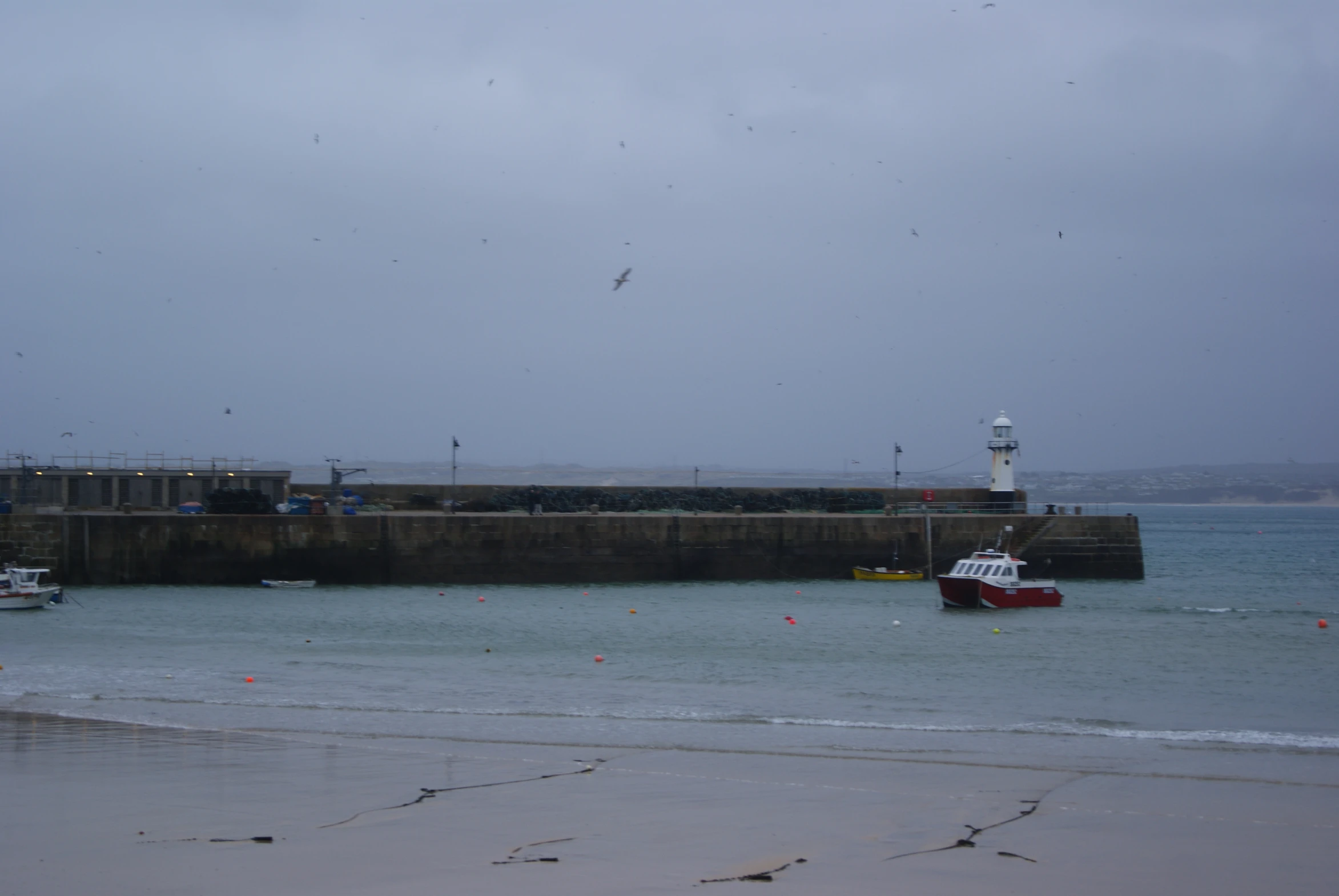 a tug boat and several other small boats on the water