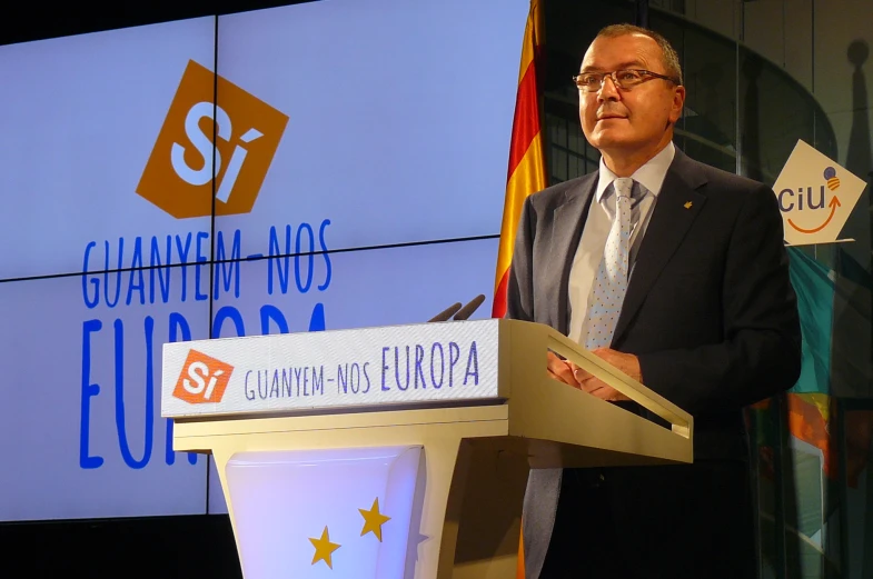 a man speaking at a podium at an event