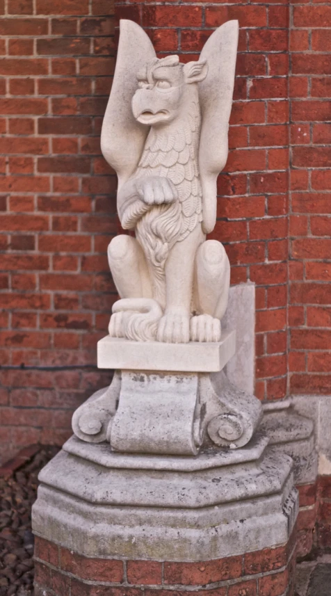 a stone statue in the corner of a building