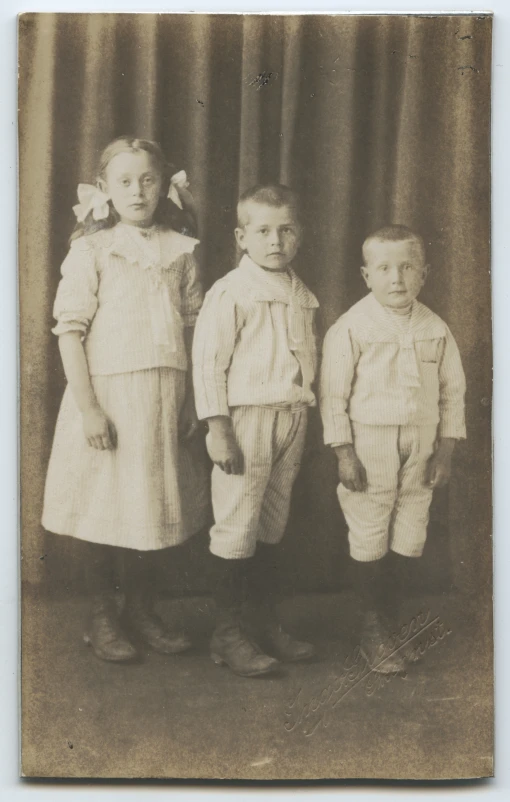 three s posing for a pograph in an antique po