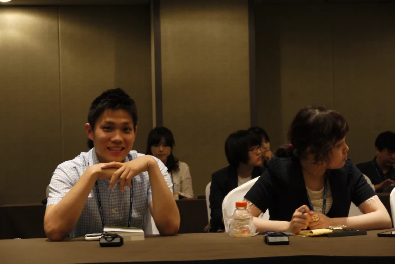 several people are sitting at the table and having conversation