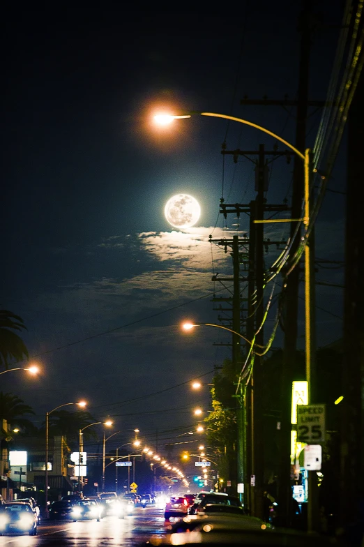 the sky is night, and the street lights are on