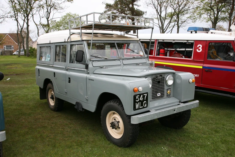 two large vehicles parked next to each other in grass