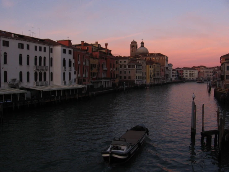 an image of a boat in the water at sunset