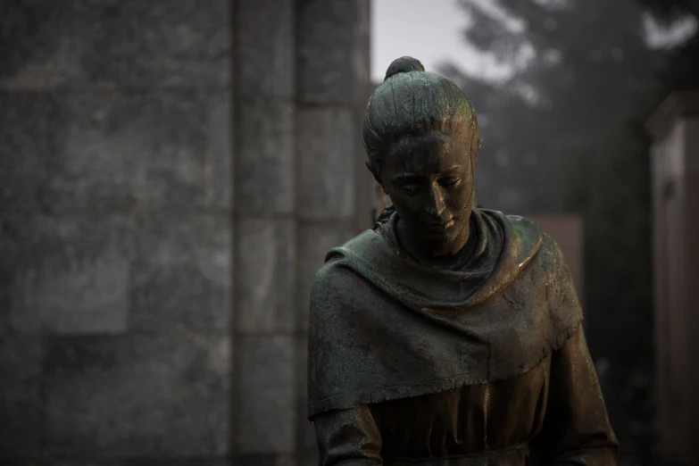 a bronze statue is shown wearing a armor