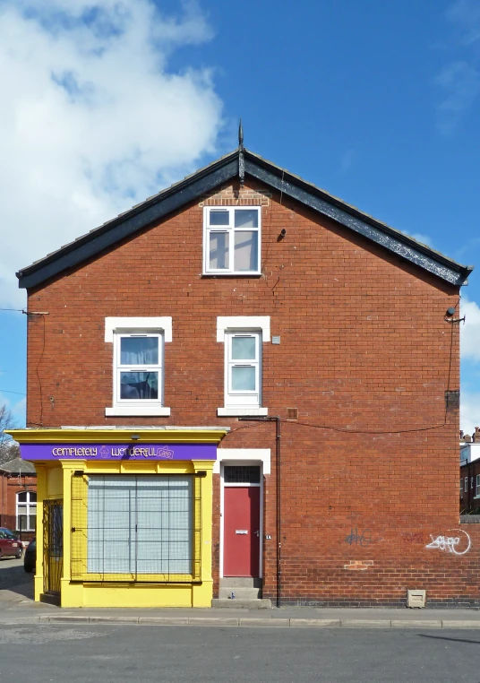 the shop is in the street and the building is painted red