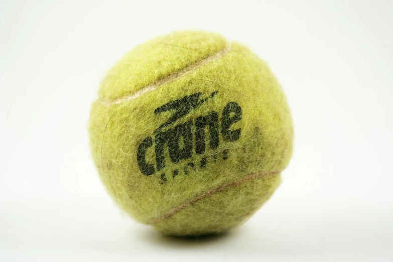 a yellow ball with the logo of a tennis club