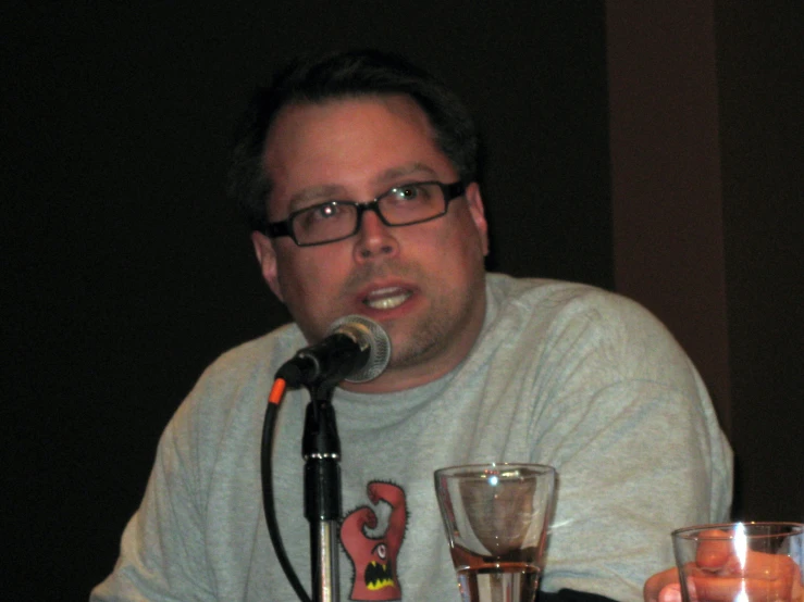 a man is sitting at a table with three wine glasses