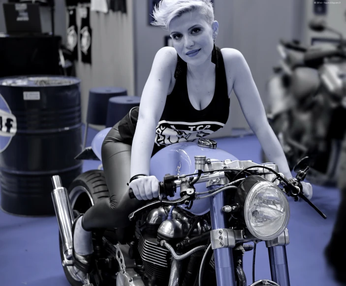 a lady that is sitting on a motorcycle