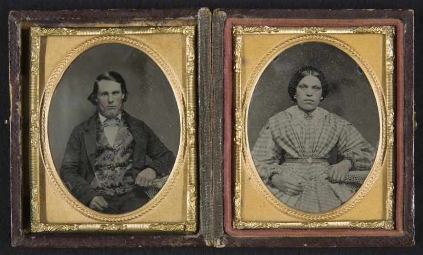 an antique pograph of two women wearing dresses