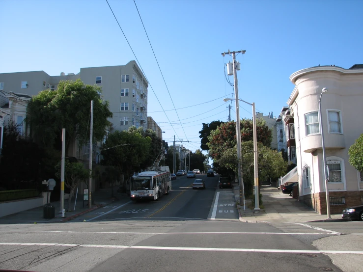 a street in a large city with buildings and trees on both sides