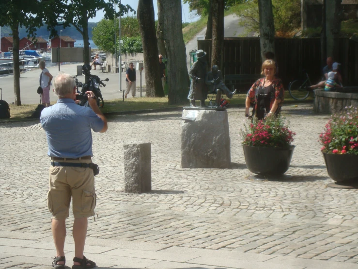 two people in the street one taking pictures