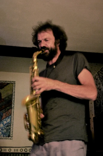 a man playing a saxophone with a black shirt