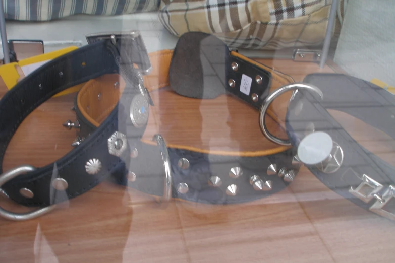 a collection of different leather collars sitting on display