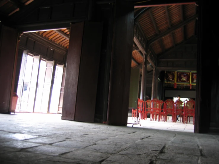 rows of red chairs in a rustic building