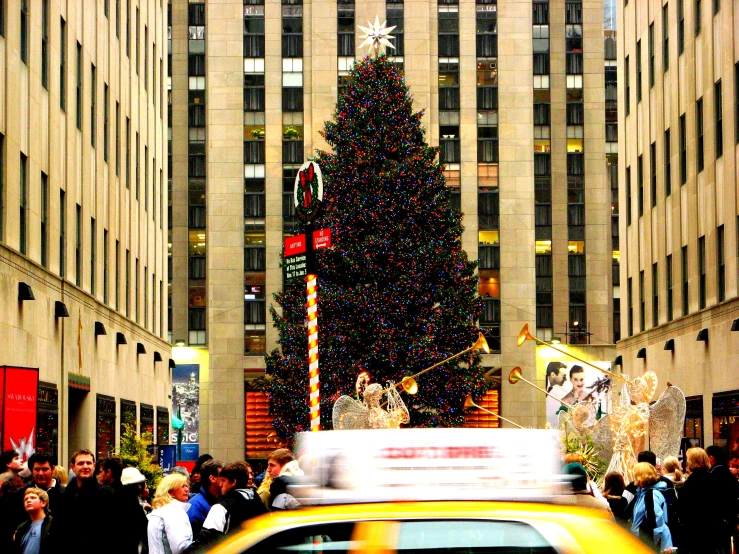 the christmas tree has lights and presents on it