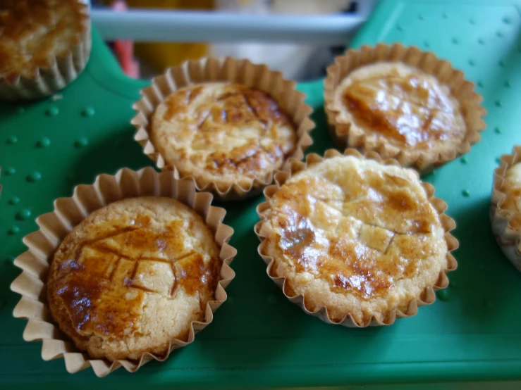 five baked desserts sit on a  board