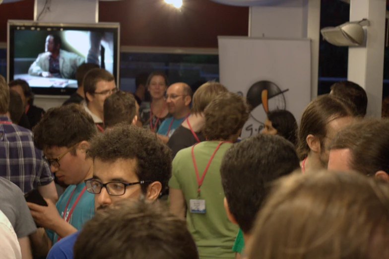 a crowded indoor event area with a group of people