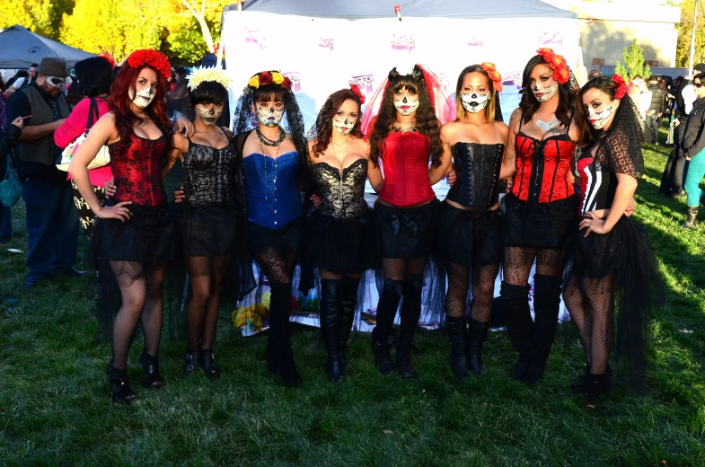 a group of women in costume with face paint