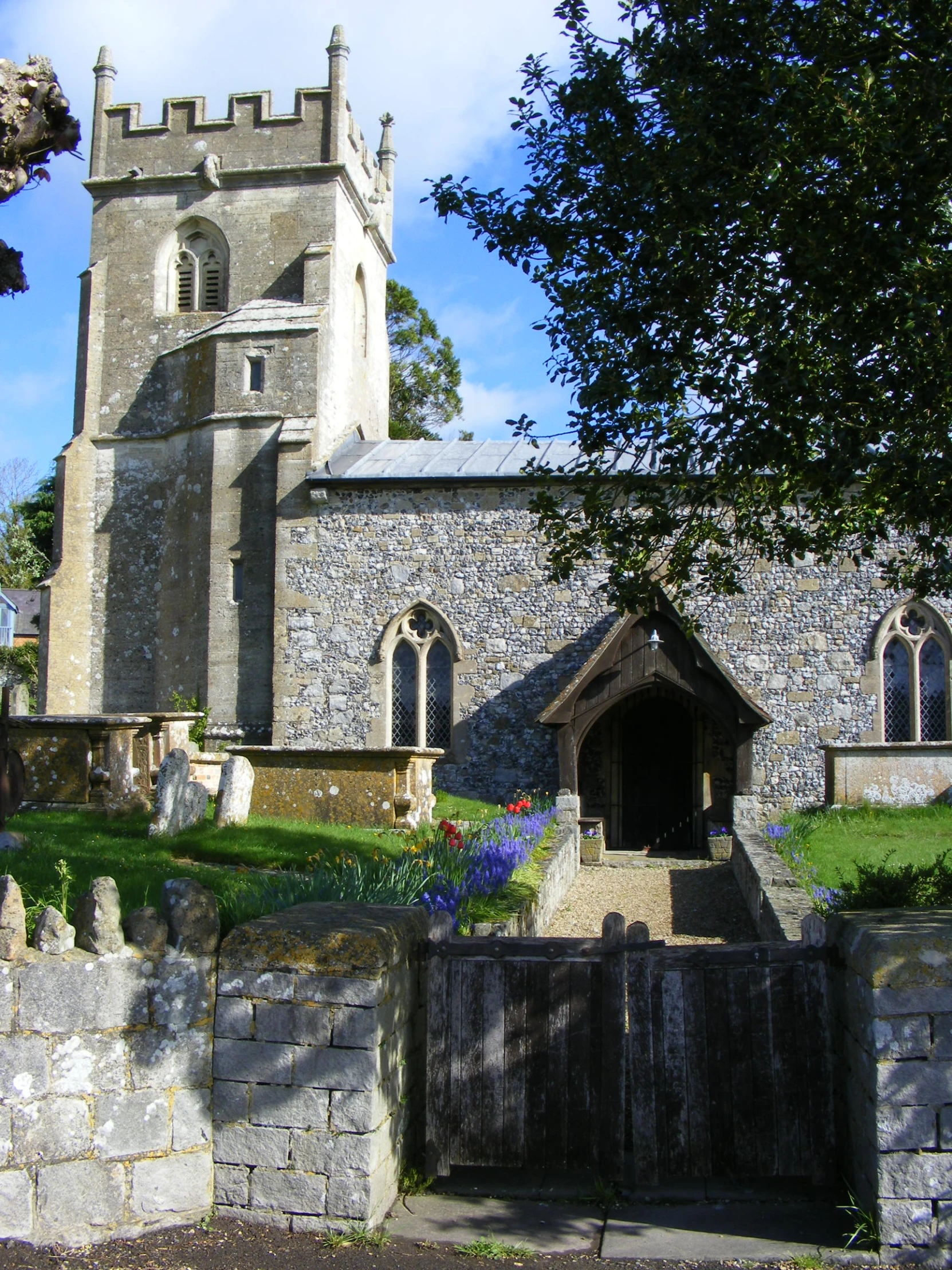 an old building with a gate and a tree