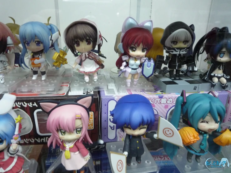 some little anime dolls sitting on display in a box