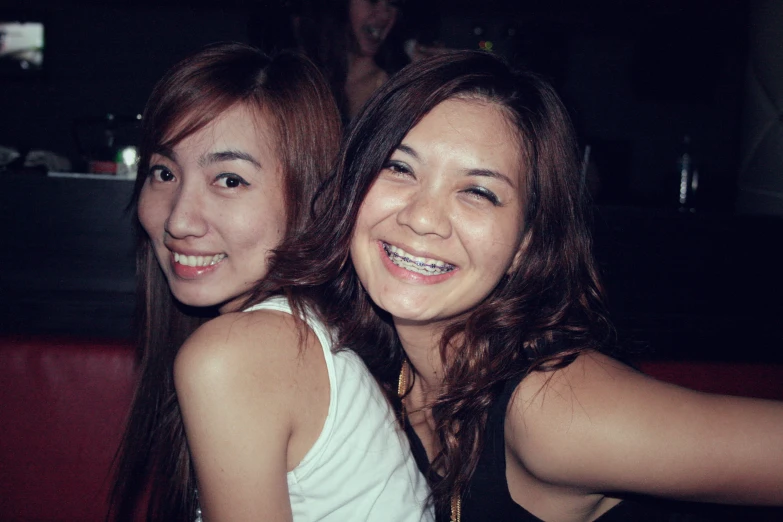 two pretty young women smiling for the camera